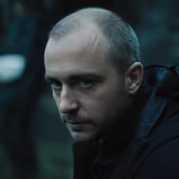 man looking away with a serious look on his face