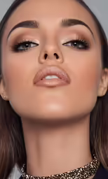 the eyes of a woman, wearing gold eye makeup