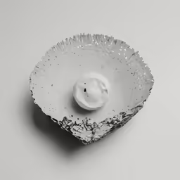 a ceramic bowl containing a small face in it