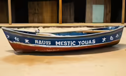 a rusty boat is painted blue and red