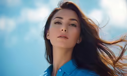 a woman with long hair wearing a blue shirt