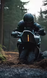 man riding a motor cycle in the forest