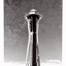 a tall tower with a clock on top in front of a clear sky