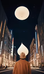 man standing under large white light fixture in city