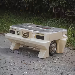a toy skateboard that is sitting on a cement slab