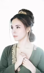 the young woman is posing in a green dress