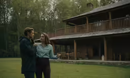 the woman in blue shirt is talking to a man