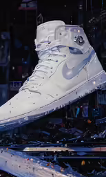 an image of nike high top in the air