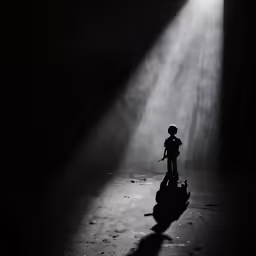 a black and white photo of a little boy on a toy