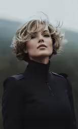 blonde hair woman looking forward with clouds above