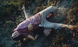 an aerial shot of a woman with bloody hands