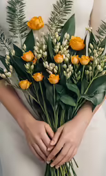 the bride is holding yellow flowers while posing
