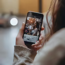 a close up of a person holding a cell phone