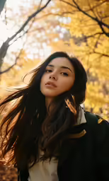 a young woman with long hair walking in the autumn