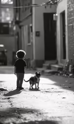 a small child walking on the street with his dog