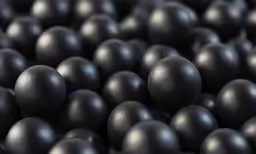 many black spheres are grouped together for a closeup photo