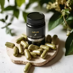 a jar of vitamins sitting on top of a cutting board