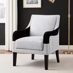 a gray, black, and white chair sitting in front of a window