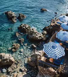 a number of beach umbrellas near the sea water