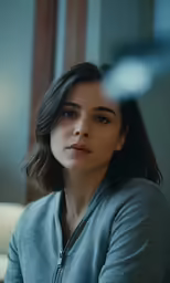 the woman is staring straight ahead in this scene