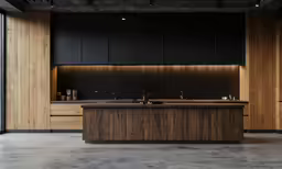 a kitchen with a long counter and wooden cabinets