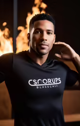 a man poses for a portrait near a fire display