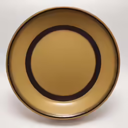 a gold plate that is on a white background