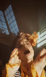 the woman is screaming while she is holding her hands up