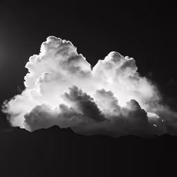 a very big beautiful cloud by the side of a mountain