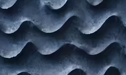 a background image with wavy shapes made from clay