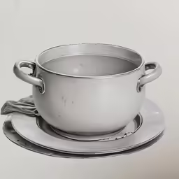 a large silver pot sits on top of plates