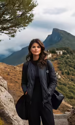 a woman wearing a black jacket stands on stairs