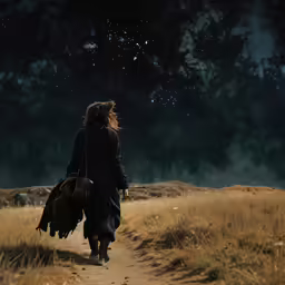 a man walking away from the camera in a grassy field