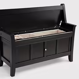 black bench with two drawers and a white floor