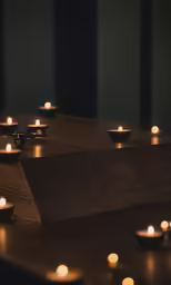 lit candles in the dark on a table