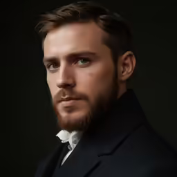 a man in a tuxedo with blue eyes