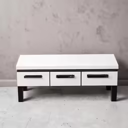 a black and white dresser sitting on a wall