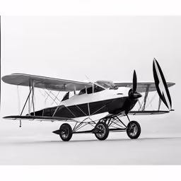 an older plane parked in the snow with wheels out
