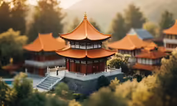 an ornate asian building is shown with mountains in the background