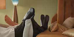 a person is lying down on a bed with a lamp next to him