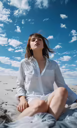 a young woman is sitting on a blanket with her eyes closed