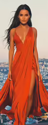 a beautiful woman in an orange dress poses for the camera