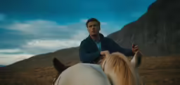 a man riding on the back of a white horse