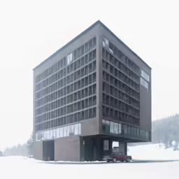 an empty parking lot is in front of a building that has large windows