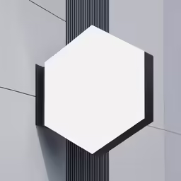 a white and black hexagon shaped object hangs on the side of a building