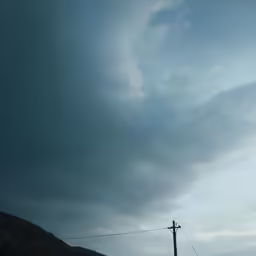 a pole is at the base of a dark mountain