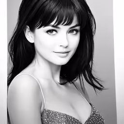 a black and white photo of a young woman in dress
