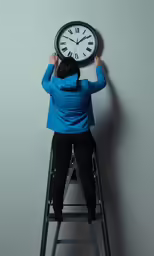 a person on top of a ladder with a clock