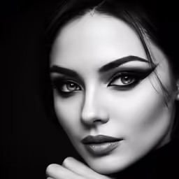 black and white photo of a woman with dark makeup