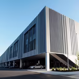 this is a large building that has several cars parked outside it